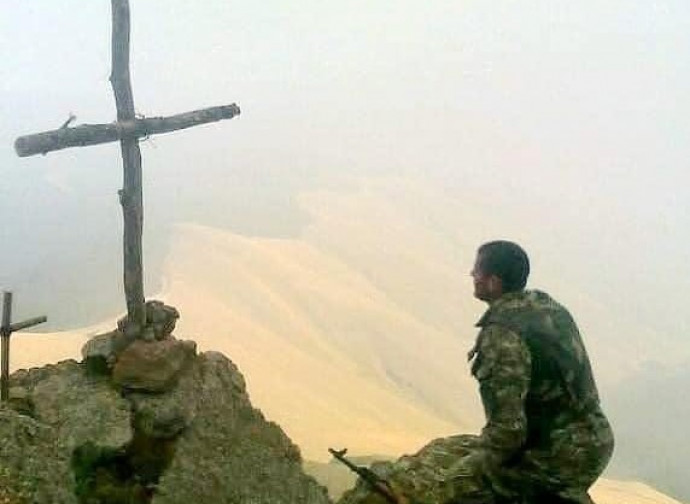 Soldato prega davanti alla Croce